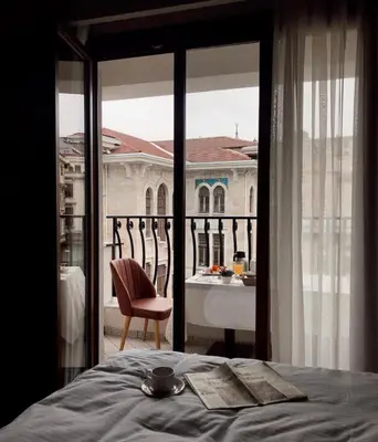 a bedroom with a bed and a view of a building at Grand Sirkeci Hotel in Istanbul