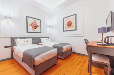 a hotel room with two beds and a desk at Ferman Port Hotel - Special Category in Istanbul