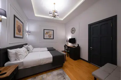 a bedroom with a bed and a desk and a door at Ferman Port Hotel - Special Category in Istanbul