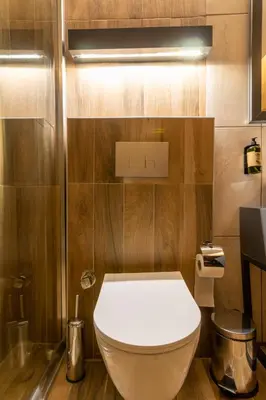 a white toilet in a bathroom with wooden walls at RUSH HOTEL İSTANBUL in Istanbul