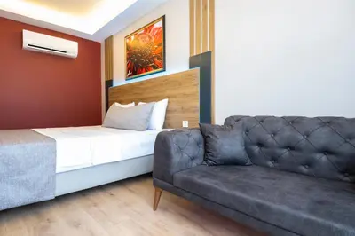 a bedroom with a bed and a couch in a room at RUSH HOTEL İSTANBUL in Istanbul