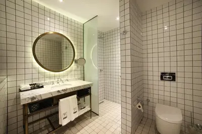 a bathroom with a sink and a mirror and a toilet at 39 Kalamış Marina Hotel & Restaurant in Istanbul