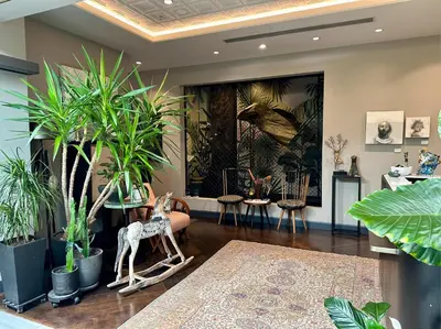 a room with plants and a statue of a giraffe at 39 Kalamış Marina Hotel & Restaurant in Istanbul