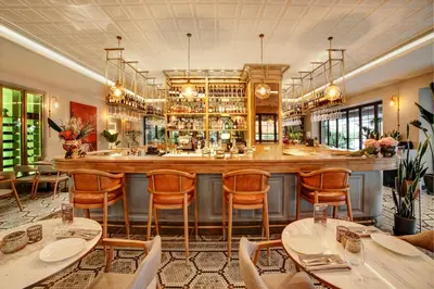 a bar in a restaurant with tables and chairs at 39 Kalamış Marina Hotel & Restaurant in Istanbul