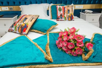 a bed with two roses in the shape of a heart at Atlantis Royal Hotel in Istanbul