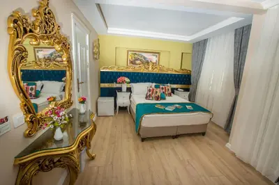 a bedroom with a bed and a large mirror at Atlantis Royal Hotel in Istanbul