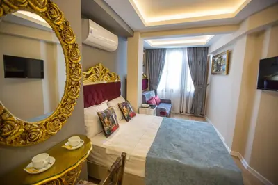 a hotel room with a bed and a mirror at Atlantis Royal Hotel in Istanbul