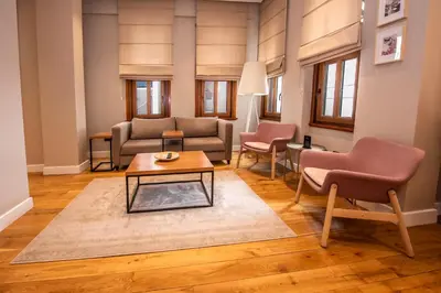 a living room with a couch and a table and chairs at Bguest Pera Suites in Istanbul