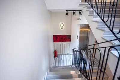 a staircase in a house with a red blanket on the wall at Bguest Pera Suites in Istanbul