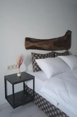a bedroom with a bed with a table next to it at PANDAN KARAKOY SUİT in Istanbul