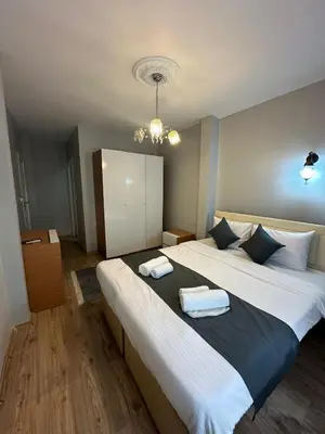 a bedroom with two beds and a chandelier at Rose Bouquets Hotel in Istanbul