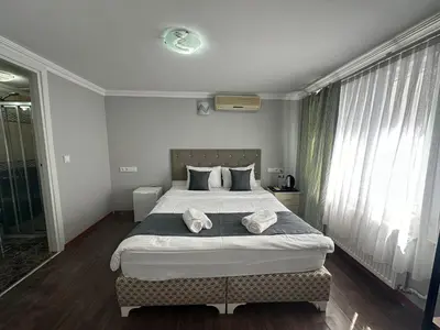 a bedroom with a large bed with two towels on it at Rose Bouquets Hotel in Istanbul