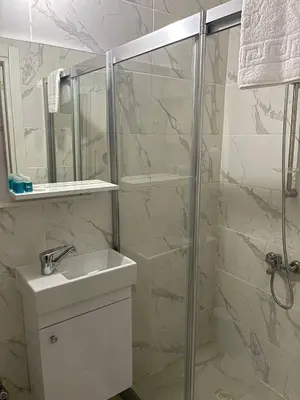 a bathroom with a shower and a sink and a mirror at Rose Bouquets Hotel in Istanbul