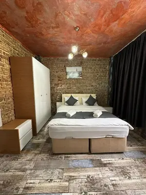 a bedroom with a bed and a brick wall at Rose Bouquets Hotel in Istanbul