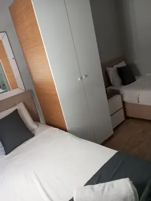 a small bedroom with a bed and a closet at Rose Bouquets Hotel in Istanbul