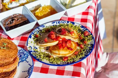 a plate of pancakes on a table with other desserts at Best Point Suites Old City,Istanbul in Istanbul
