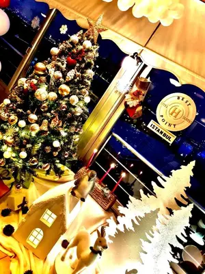 a christmas tree with christmas decorations on a table at Best Point Suites Old City,Istanbul in Istanbul