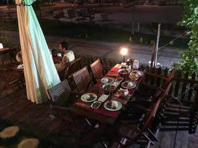 a table with plates of food on top of a patio at Ağva Piassa Otel in Agva
