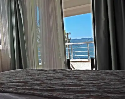 a bedroom with a bed and a view of the ocean at Senler Boutique Hotel in Sapanca