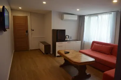 a living room with a red couch and a table at Senler Boutique Hotel in Sapanca