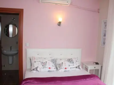 a bedroom with a white bed and a sink at Sapphire Hotel in Agva