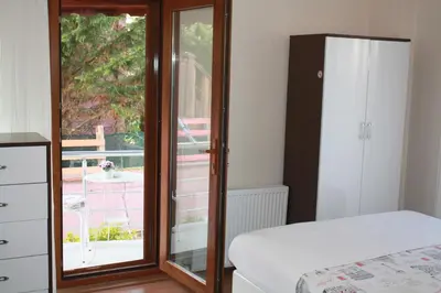 a bedroom with a bed and a sliding glass door at Sapphire Hotel in Agva