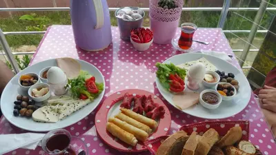 a pink table with plates of food on it at Sapphire Hotel in Agva