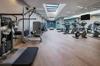 a gym with several treadmills and cardio machines at DoubleTree by Hilton Istanbul Gayrettepe in Istanbul