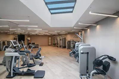 a gym with rows of treadmills and cardio machines at DoubleTree by Hilton Istanbul Gayrettepe in Istanbul