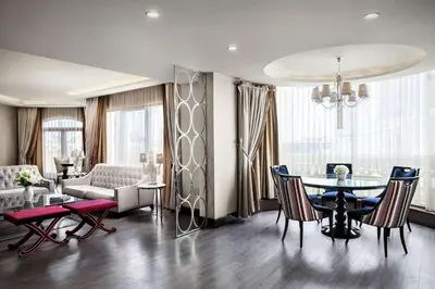 a living room with a table and chairs and a couch at DoubleTree by Hilton Istanbul Gayrettepe in Istanbul
