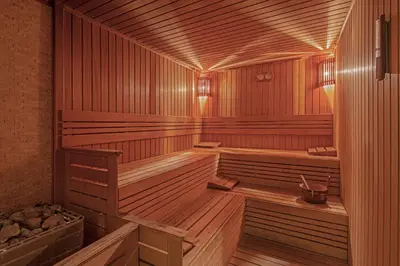 a wooden sauna with two benches in it at DoubleTree by Hilton Istanbul Gayrettepe in Istanbul