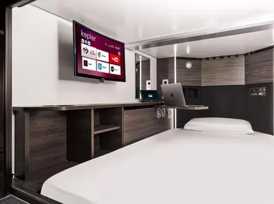 a bedroom with a bed and a tv on a wall at Kepler Club Sabiha Gökçen Airport - International Transit Area in Istanbul