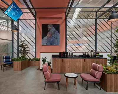 a waiting room with pink chairs and a picture of a man at Kepler Club Sabiha Gökçen Airport - International Transit Area in Istanbul