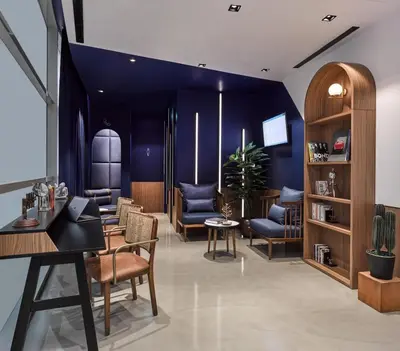 a salon with blue walls and chairs at Kepler Club Sabiha Gökçen Airport - International Transit Area in Istanbul