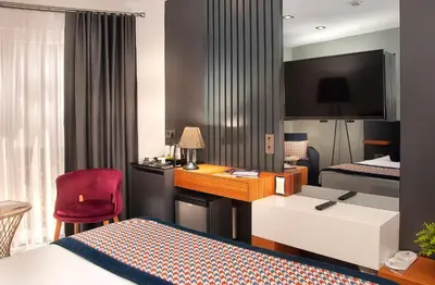 a hotel room with a bed and a desk at Ooda Rooms Kadıköy in Istanbul