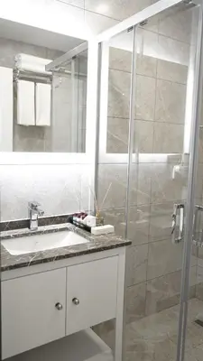 a bathroom with a sink and a glass shower at Ooda Rooms Kadıköy in Istanbul