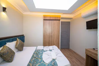 a hotel room with a bed and a television at Hotel Simper in Istanbul