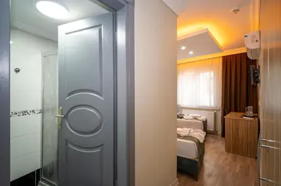 a bathroom with a door leading to a bedroom at Hotel Simper in Istanbul