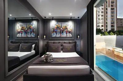 a bedroom with two beds and a large window at Ataşehir The Place Suites in Istanbul
