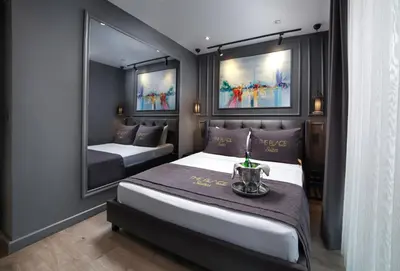 a bedroom with two beds and a mirror at Ataşehir The Place Suites in Istanbul