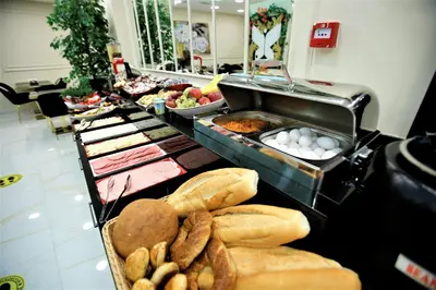 a buffet line with different types of bread and pastries at OMMA HOTEL in Istanbul