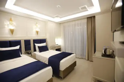 a hotel room with two beds and a television at OMMA HOTEL in Istanbul