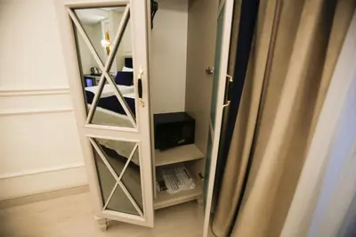 a mirror in a room next to a refrigerator at OMMA HOTEL in Istanbul