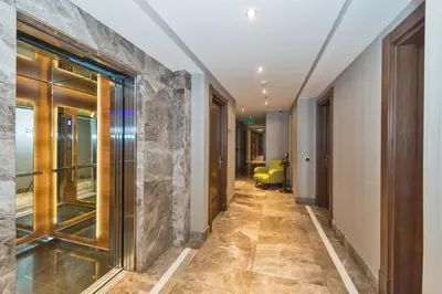 a hallway of a hotel with a stone wall at Istanbul Dora Hotel in Istanbul