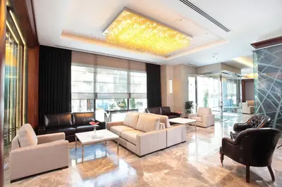 a living room with leather furniture and a skylight at Istanbul Dora Hotel in Istanbul