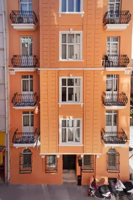 an orange building with balconies on the side of it at taxim cool in Istanbul