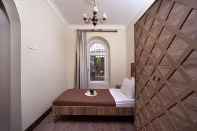 a room with a bed and a wooden door at taxim cool in Istanbul