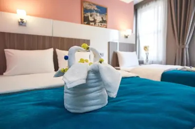 a towel animal sitting on a bed in a hotel room at Renzo Hotel - Special Category in Istanbul