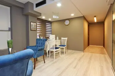 a living room with blue chairs and a table at Renzo Hotel - Special Category in Istanbul