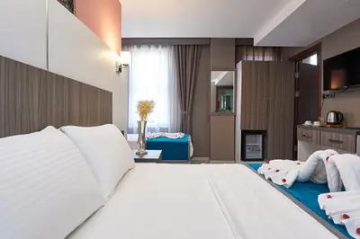 a bedroom with a large white bed with towels on it at Renzo Hotel - Special Category in Istanbul